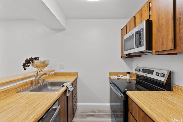4580 Matich Dr, Reno, NV 89502 - kitchen featuring appliances with stainless steel finishes, a sink, and brown cabinetry