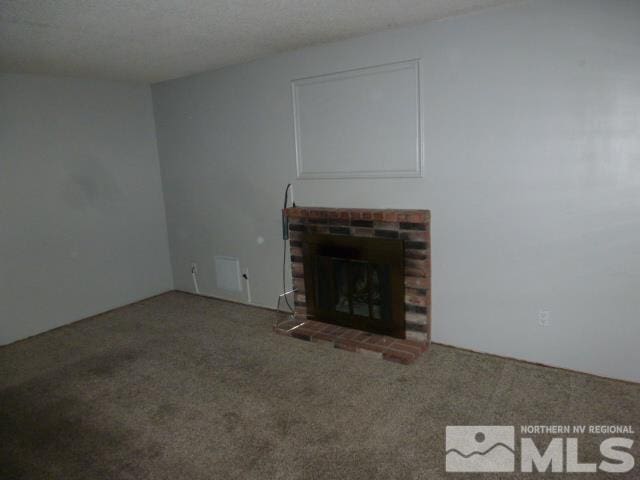 4650 Rio Poco Rd, Reno, NV 89502 - unfurnished living room featuring carpet floors and a brick fireplace