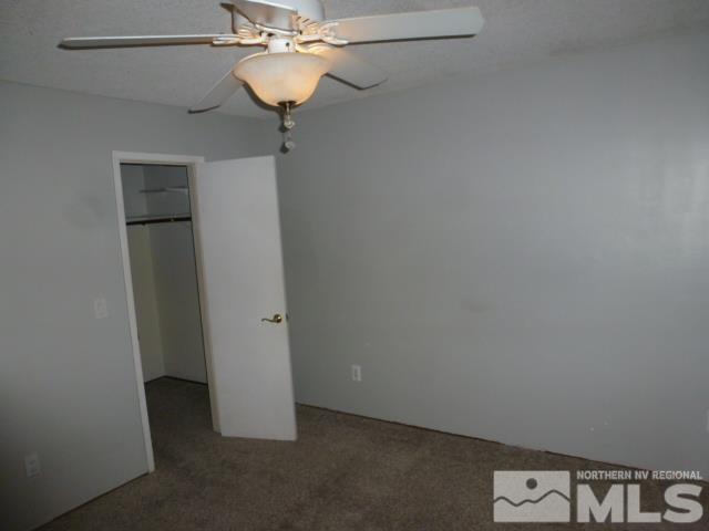 4650 Rio Poco Rd, Reno, NV 89502 - unfurnished bedroom with carpet, ceiling fan, and a closet