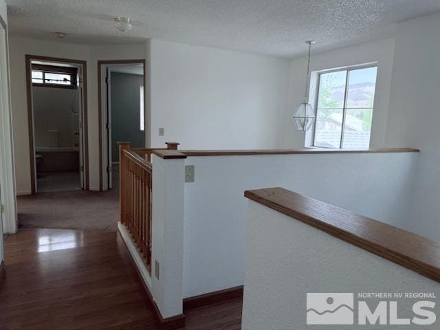 6700 Sandia Dr, Reno, NV 89523 - corridor featuring plenty of natural light, dark wood-type flooring, an upstairs landing, a textured ceiling, and baseboards