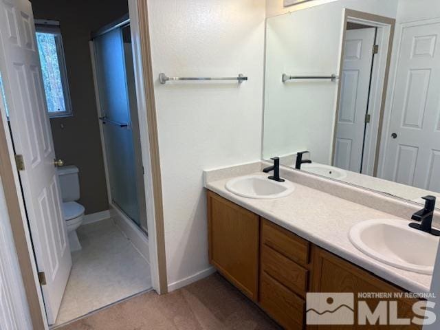 6700 Sandia Dr, Reno, NV 89523 - full bath featuring toilet, a shower stall, double vanity, and baseboards