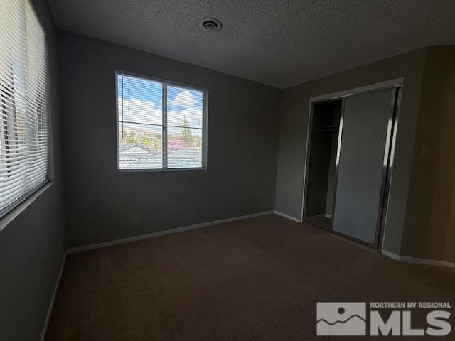 6700 Sandia Dr, Reno, NV 89523 - unfurnished bedroom with a textured ceiling, carpet, baseboards, and a closet