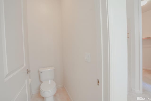 9900 Wilbur May Unit 3403, Reno, NV 89521 - bathroom with baseboards, toilet, and tile patterned floors