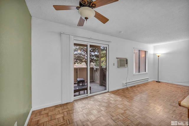 3865 E Leonesio Dr Unit F1, Reno, NV 89512 - empty room with a baseboard heating unit, a textured ceiling, a wall mounted AC, baseboards, and a ceiling fan
