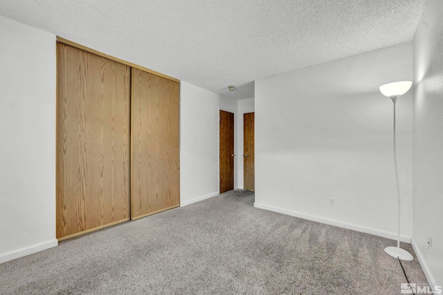 3865 E Leonesio Dr Unit F1, Reno, NV 89512 - unfurnished bedroom with carpet flooring, a textured ceiling, a closet, and baseboards