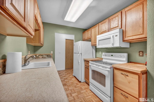 3865 E Leonesio Dr Unit F1, Reno, NV 89512 - kitchen with white appliances, a sink, wooden counters, and light brown cabinets