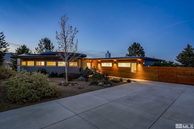 2040 Scharr Cir, Reno, NV 89509 - view of front facade with roof mounted solar panels, a chimney, and fence