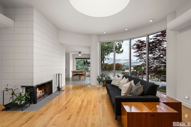 2040 Scharr Cir, Reno, NV 89509 - living area featuring a fireplace, light wood-style flooring, recessed lighting, and a ceiling fan