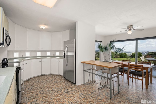 2040 Scharr Cir, Reno, NV 89509 - kitchen featuring appliances with stainless steel finishes, a ceiling fan, white cabinetry, and light countertops