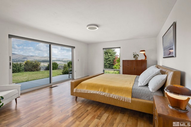 2040 Scharr Cir, Reno, NV 89509 - bedroom with access to exterior and wood finished floors
