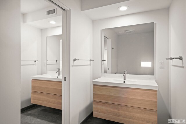 2040 Scharr Cir, Reno, NV 89509 - bathroom with two vanities, recessed lighting, baseboards, and tile patterned floors