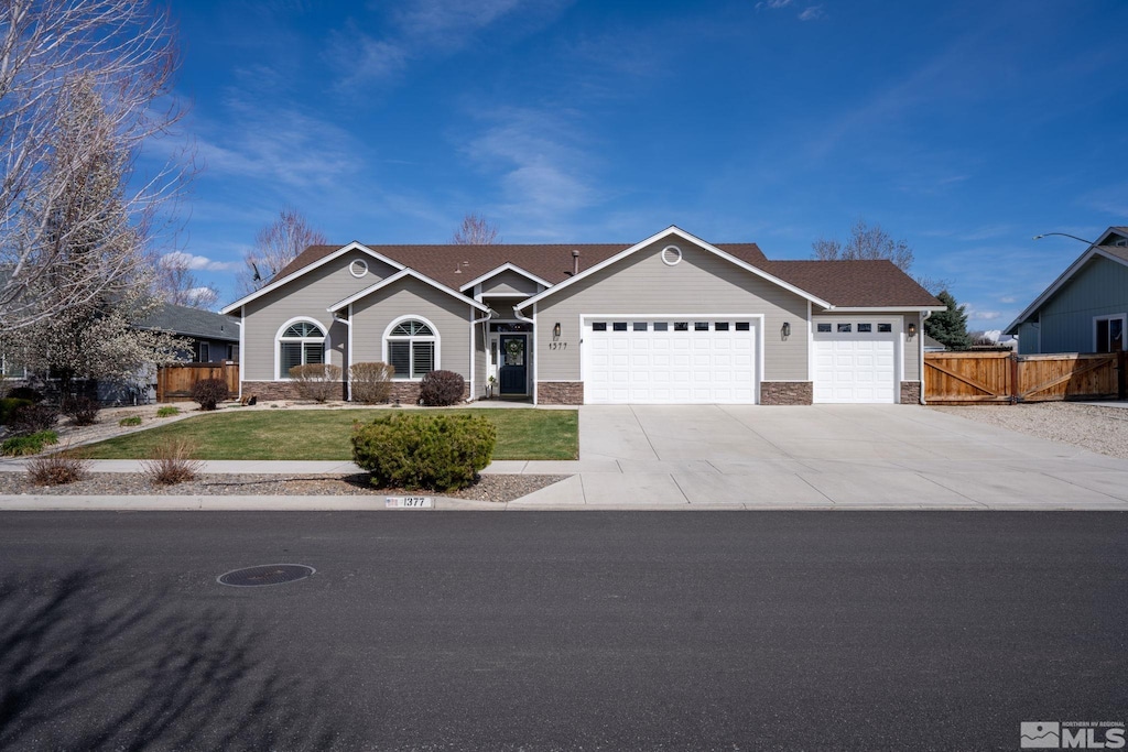 1377 Stodick Ln, Gardnerville, NV 89410 - ranch-style home featuring an attached garage, driveway, and stone siding