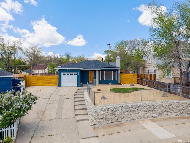 983 Melba Dr, Reno, NV 89503 - view of front of home featuring a garage, driveway, a fenced front yard, a chimney, and roof with shingles