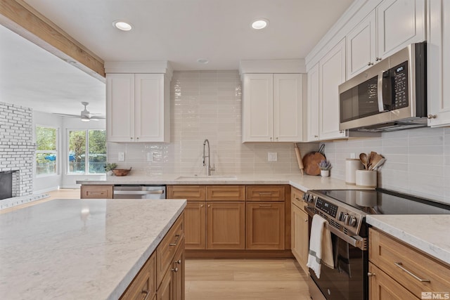 983 Melba Dr, Reno, NV 89503 - kitchen featuring stainless steel appliances, a sink, tasteful backsplash, white cabinetry, and recessed lighting