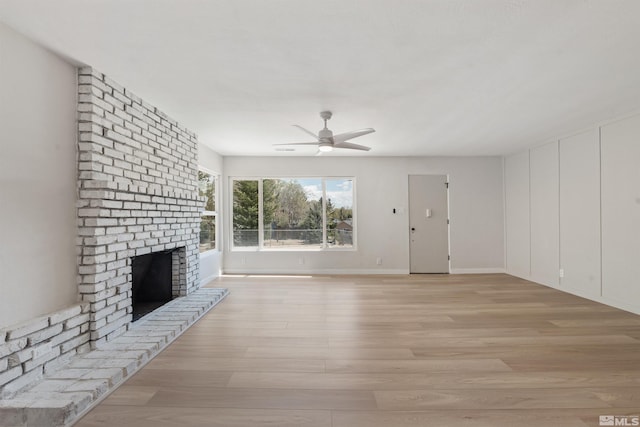 983 Melba Dr, Reno, NV 89503 - unfurnished living room featuring light wood-style floors, a brick fireplace, a ceiling fan, and baseboards