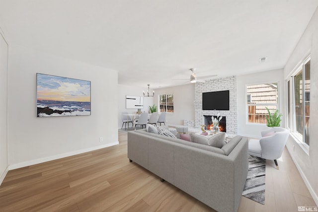 983 Melba Dr, Reno, NV 89503 - living area featuring light wood-style floors, ceiling fan, a brick fireplace, and baseboards