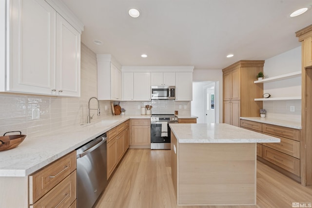 983 Melba Dr, Reno, NV 89503 - kitchen featuring appliances with stainless steel finishes, open shelves, a sink, tasteful backsplash, and a kitchen island