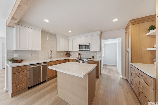 983 Melba Dr, Reno, NV 89503 - kitchen with stainless steel appliances, light wood-type flooring, open shelves, tasteful backsplash, and recessed lighting