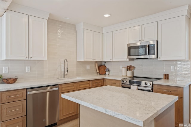 983 Melba Dr, Reno, NV 89503 - kitchen featuring stainless steel appliances, a sink, light stone counters, white cabinetry, and recessed lighting