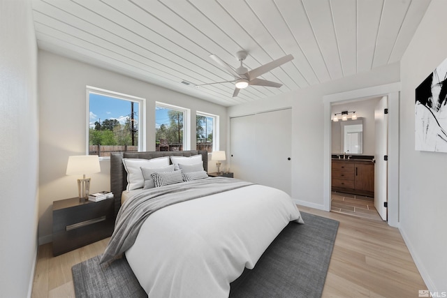 983 Melba Dr, Reno, NV 89503 - bedroom featuring light wood-style floors, ensuite bathroom, a sink, baseboards, and a closet