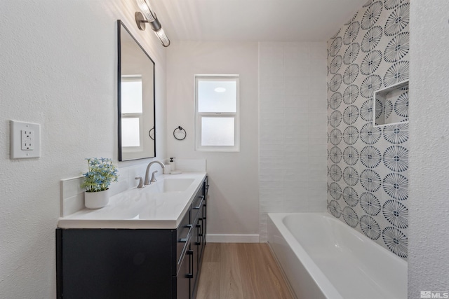 983 Melba Dr, Reno, NV 89503 - full bath with wood finished floors, vanity, and washtub / shower combination