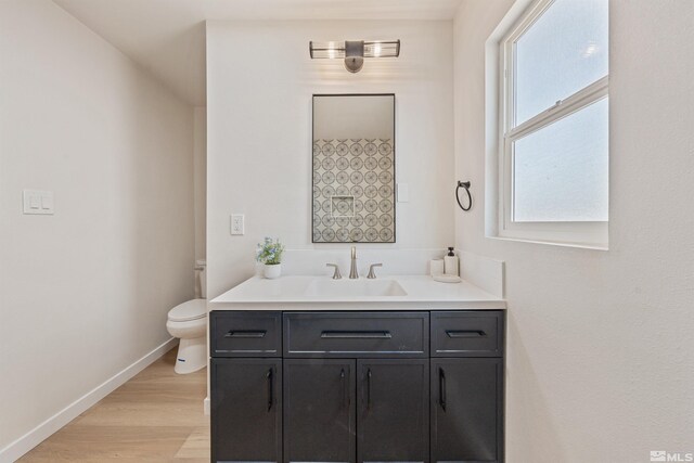 983 Melba Dr, Reno, NV 89503 - bathroom featuring vanity, baseboards, wood finished floors, and toilet
