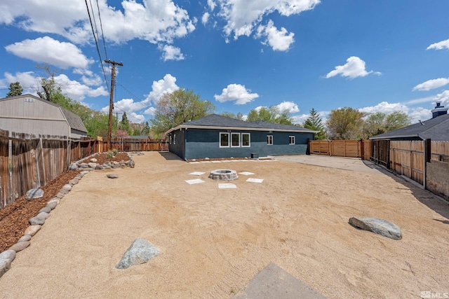 983 Melba Dr, Reno, NV 89503 - back of house featuring an outdoor fire pit, a fenced backyard, and stucco siding