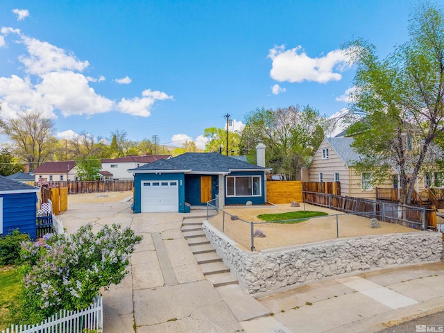 983 Melba Dr, Reno, NV 89503 - single story home with an attached garage, a fenced front yard, concrete driveway, and a chimney