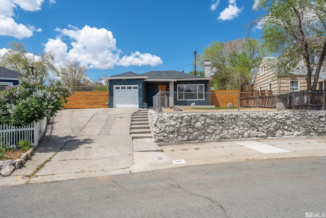 983 Melba Dr, Reno, NV 89503 - view of front facade with an attached garage, a fenced front yard, and driveway