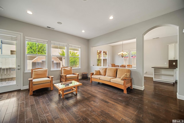 7609 Stone Bluff Way, Reno, NV 89523 - living room featuring arched walkways, wood-type flooring, baseboards, recessed lighting, and a chandelier
