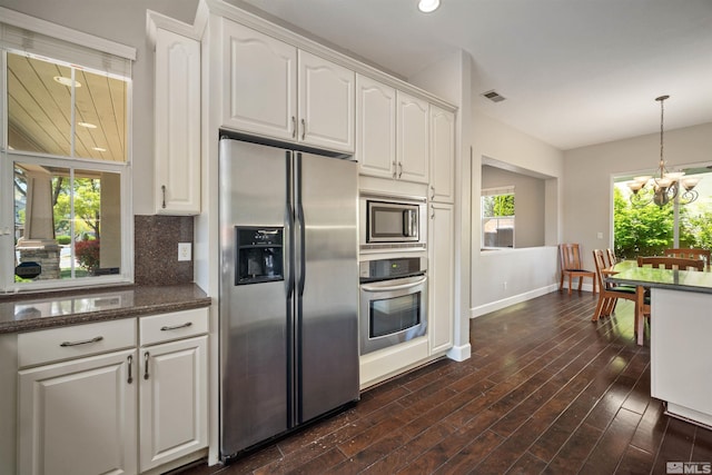 7609 Stone Bluff Way, Reno, NV 89523 - kitchen featuring stainless steel appliances, white cabinets, baseboards, a chandelier, and backsplash
