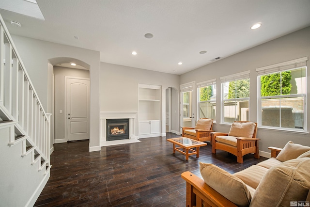 7609 Stone Bluff Way, Reno, NV 89523 - living room featuring baseboards, hardwood / wood-style flooring, built in features, recessed lighting, and arched walkways