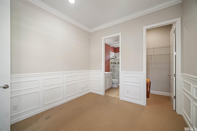 7609 Stone Bluff Way, Reno, NV 89523 - unfurnished bedroom featuring light colored carpet, ornamental molding, a decorative wall, a walk in closet, and a closet
