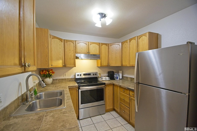 2375 Tripp Dr # 10, Reno, NV 89512 - kitchen featuring stainless steel appliances, a sink, under cabinet range hood, and light tile patterned floors