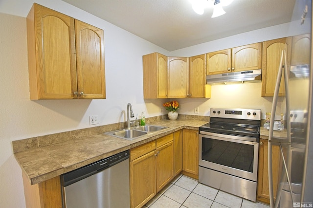 2375 Tripp Dr # 10, Reno, NV 89512 - kitchen with stainless steel appliances, a sink, under cabinet range hood, light tile patterned floors, and tile counters
