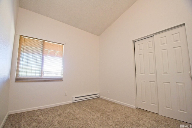 2375 Tripp Dr # 10, Reno, NV 89512 - unfurnished bedroom featuring a baseboard radiator, lofted ceiling, light colored carpet, a closet, and baseboards