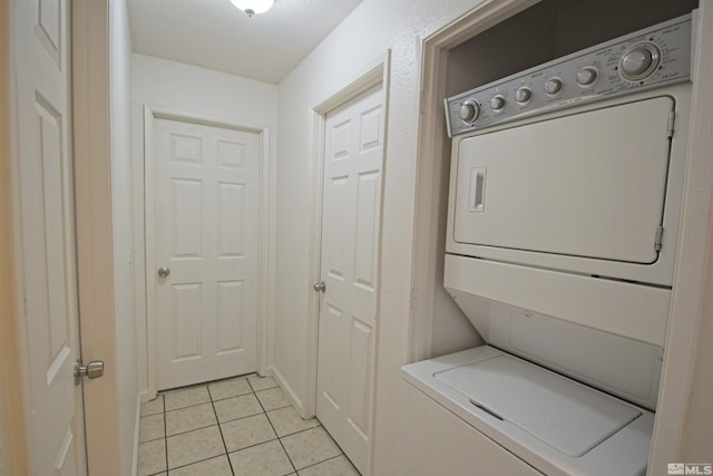 2375 Tripp Dr # 10, Reno, NV 89512 - washroom with estacked washer and dryer and light tile patterned flooring