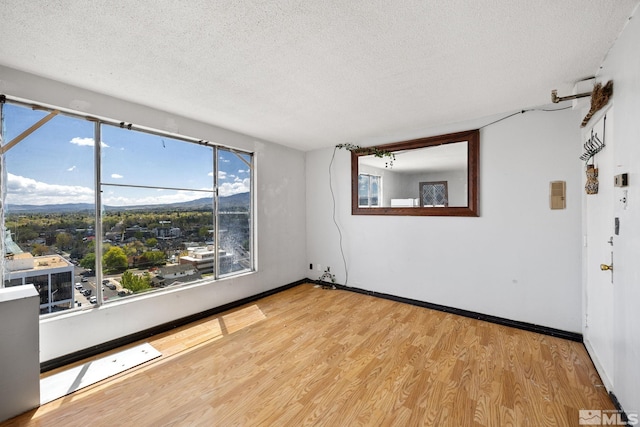 280 Island Ave Unit 1802, Reno, NV 89501 - spare room featuring a textured ceiling, wood finished floors, plenty of natural light, and baseboards