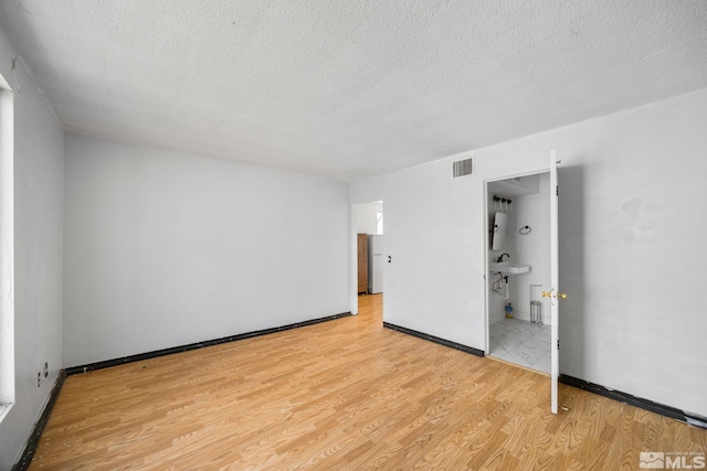 280 Island Ave Unit 1802, Reno, NV 89501 - unfurnished room with light wood-type flooring, a textured ceiling, and baseboards