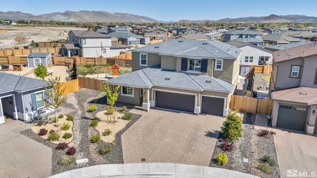 7836 Tarkio Ct, Sparks, NV 89436 - traditional-style home featuring a residential view, stucco siding, decorative driveway, fence, and a mountain view