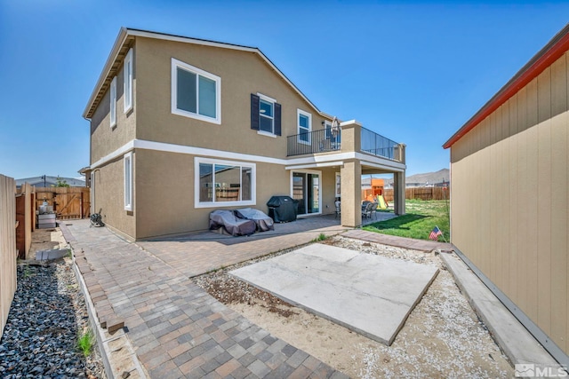 7836 Tarkio Ct, Sparks, NV 89436 - back of house with a balcony, a patio area, a fenced backyard, and stucco siding