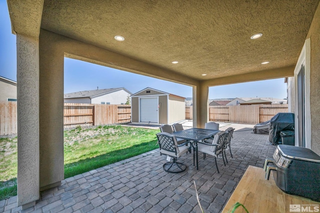 7836 Tarkio Ct, Sparks, NV 89436 - view of patio / terrace featuring a shed, a fenced backyard, an outbuilding, and outdoor dining space