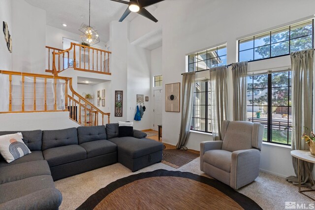 5276 Simons Dr, Reno, NV 89523 - carpeted living room with a towering ceiling, plenty of natural light, stairway, baseboards, and a ceiling fan