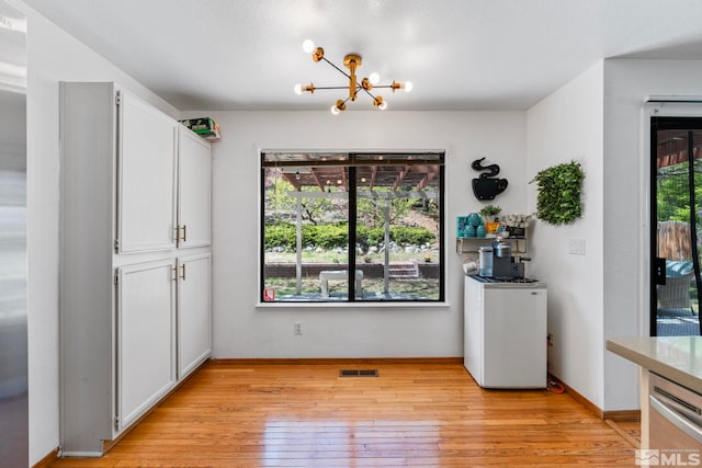 5276 Simons Dr, Reno, NV 89523 - unfurnished dining area featuring a chandelier, light wood finished floors, and baseboards
