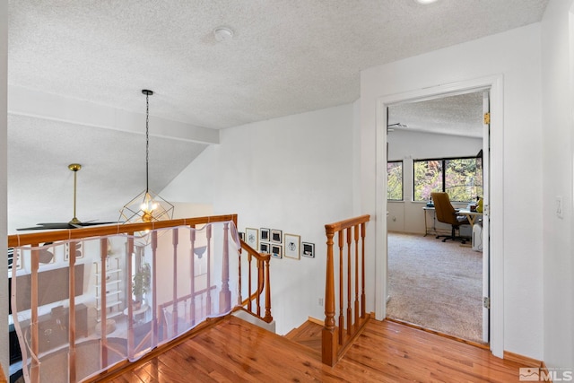 5276 Simons Dr, Reno, NV 89523 - hallway featuring an upstairs landing, a textured ceiling, an office area, wood finished floors, and a chandelier