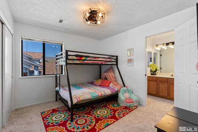 5276 Simons Dr, Reno, NV 89523 - bedroom featuring light carpet, a textured ceiling, baseboards, a closet, and a chandelier