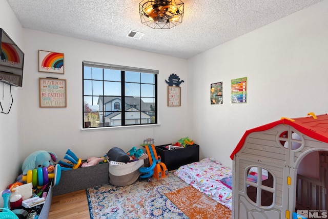 5276 Simons Dr, Reno, NV 89523 - bedroom featuring wood finished floors and a textured ceiling