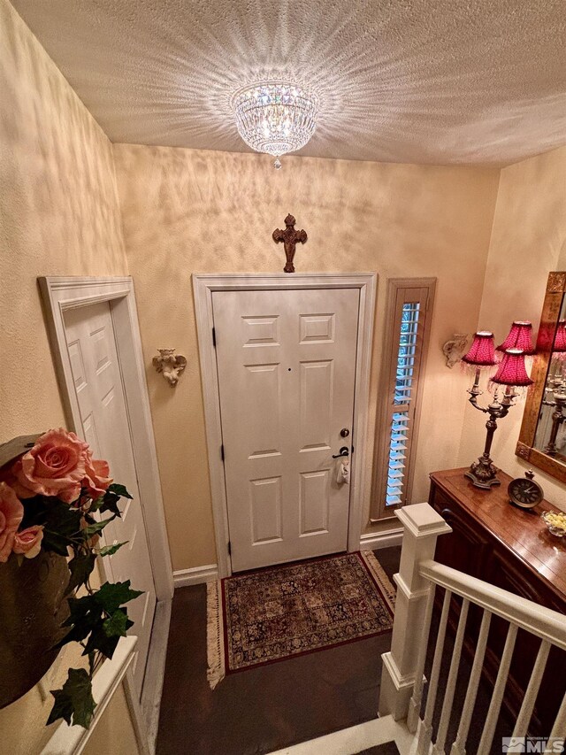 900 S Meadows Pkwy Apt 5021, Reno, NV 89521 - foyer featuring a textured ceiling, baseboards, and a chandelier
