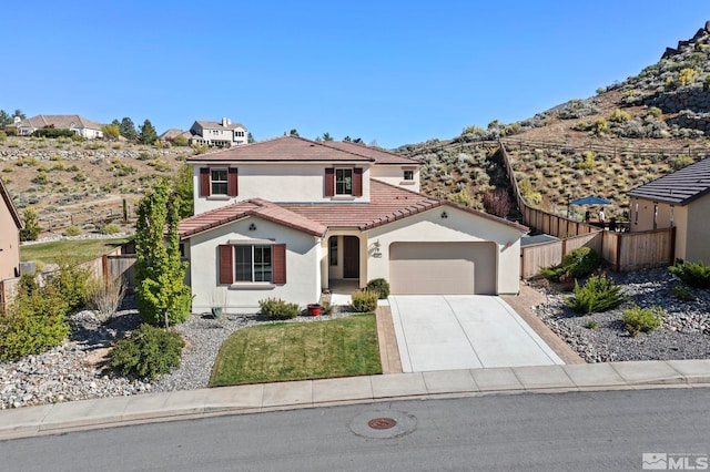 1680 Verdi Vista Ct, Reno, NV 89523 - mediterranean / spanish house featuring stucco siding, an attached garage, a tiled roof, driveway, and a mountain view