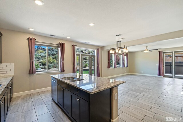 1680 Verdi Vista Ct, Reno, NV 89523 - kitchen featuring healthy amount of natural light, a kitchen island with sink, stainless steel dishwasher, ceiling fan, and recessed lighting